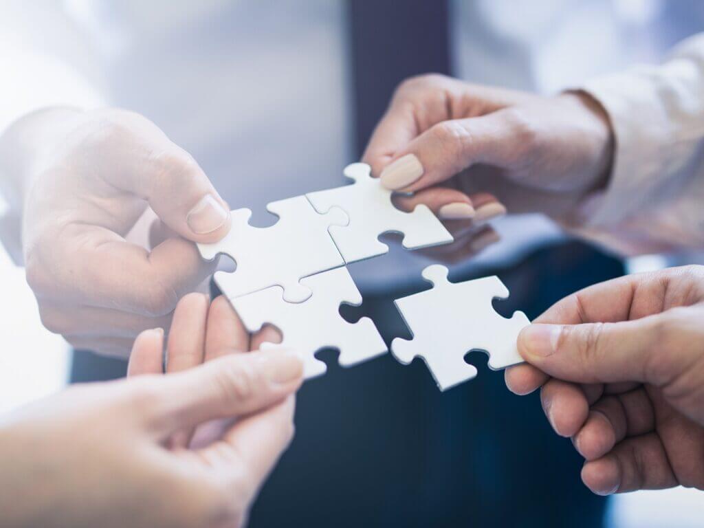 A,Group,Of,Business,People,Assembling,Jigsaw,Puzzle.,The,Concept